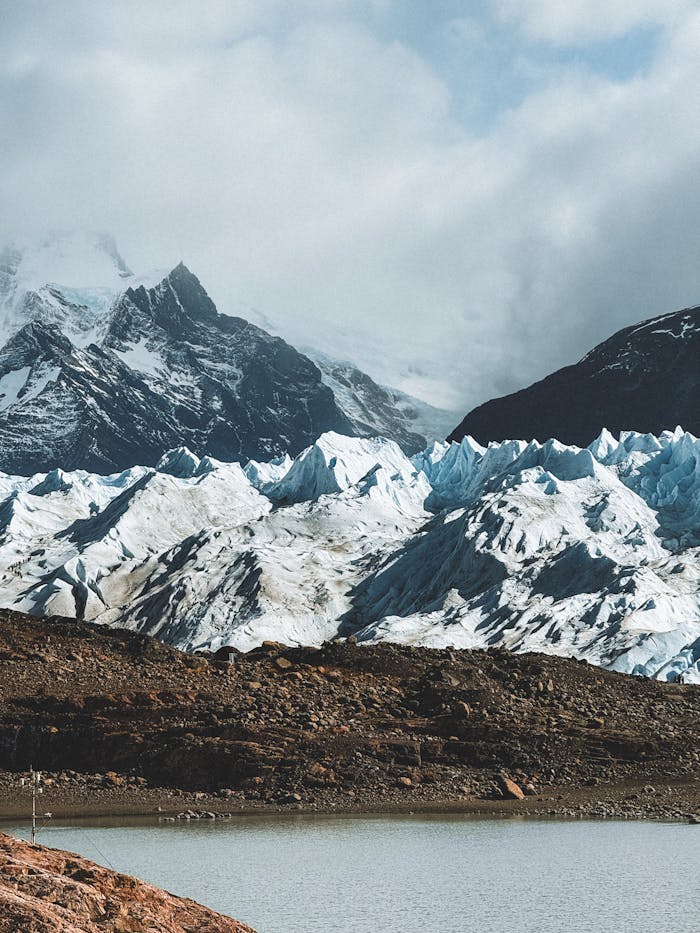 A person standing on a rock near a glacier